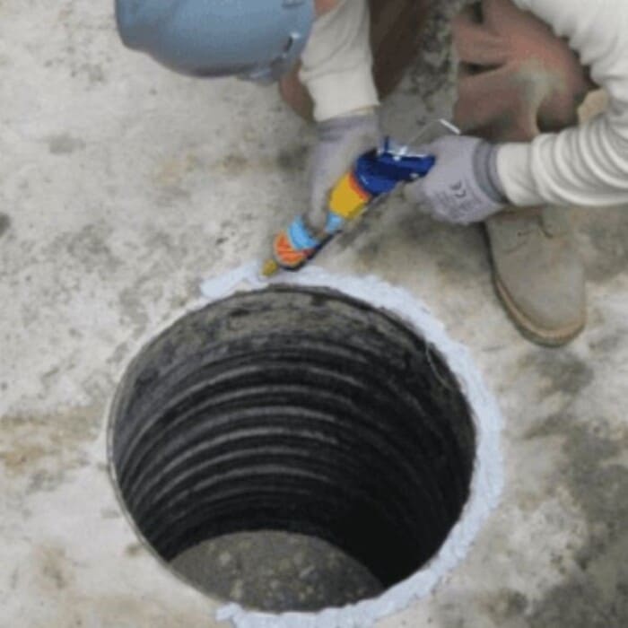 Preparing the surface to insert the PETRO BARRIER into the concrete manhole