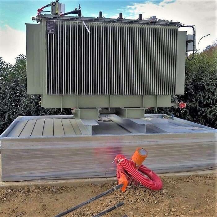 Outdoor installation of an electrical transformer on an ERT® -W bund, fire-retardant, hot-dip galvanised steel, beams adjustable in width.